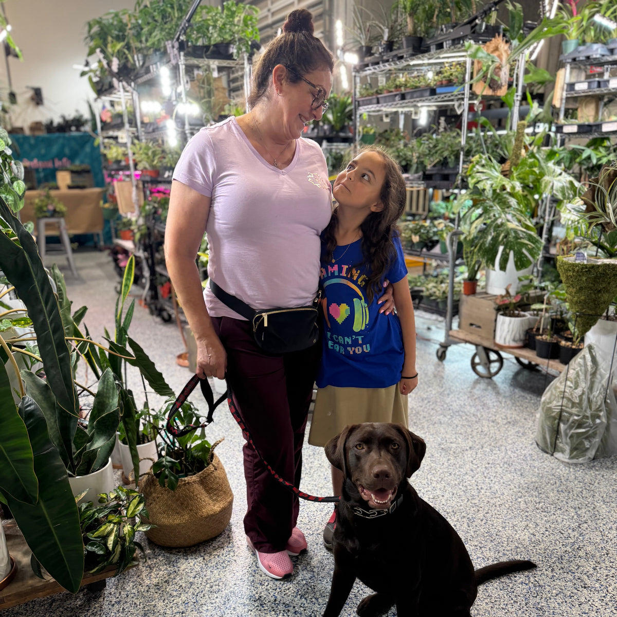 Woman, child, and dog in a plant store
