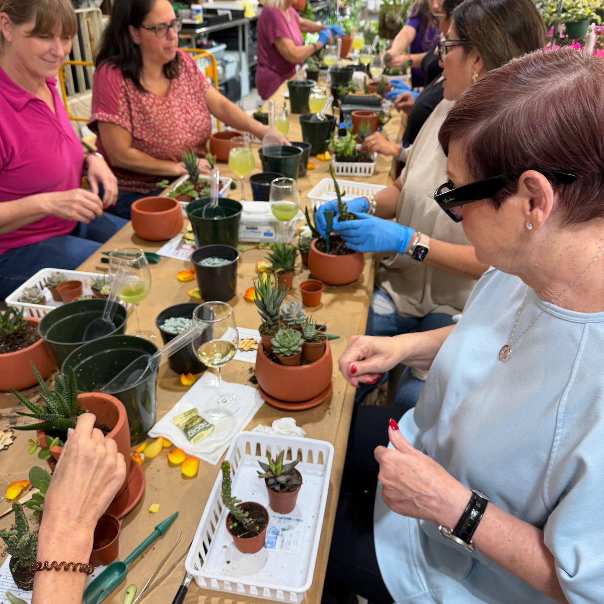Group of people working with plants in a workshop setting