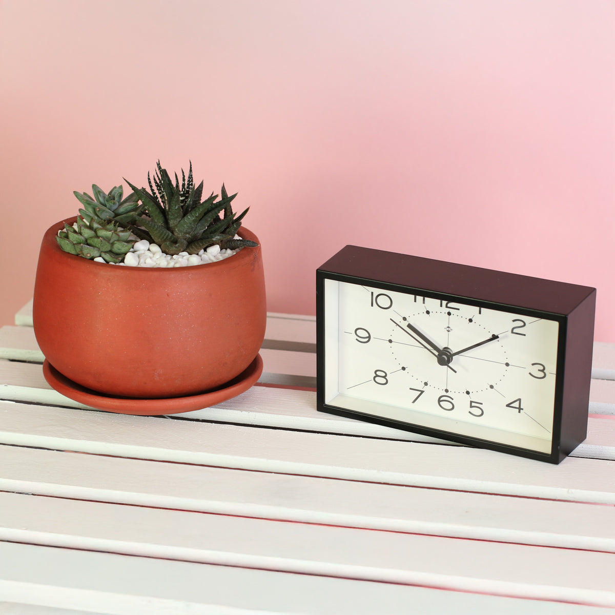 Green Escape Terracotta Creation DIY next to clock. 