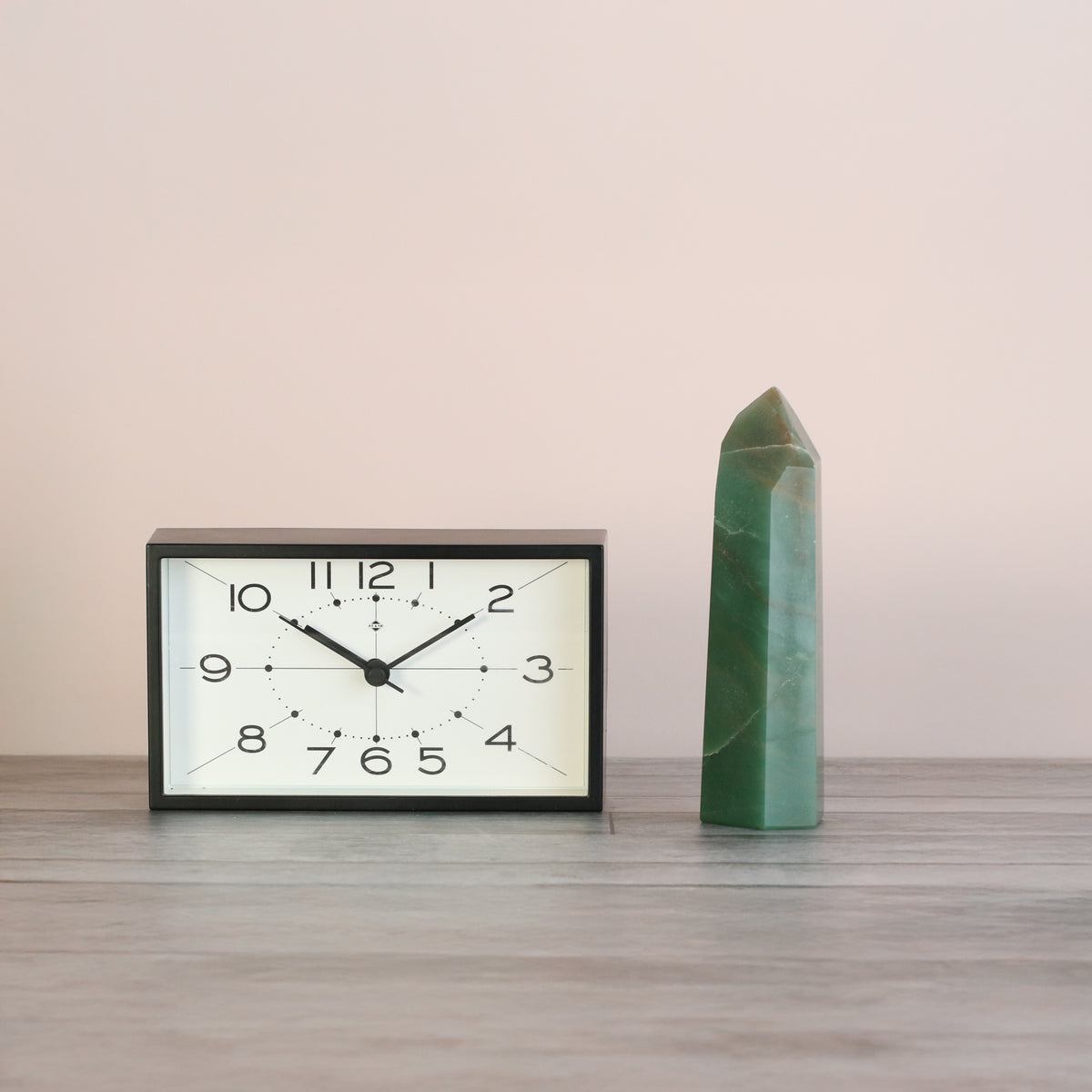 Green Aventurine Points next to clock