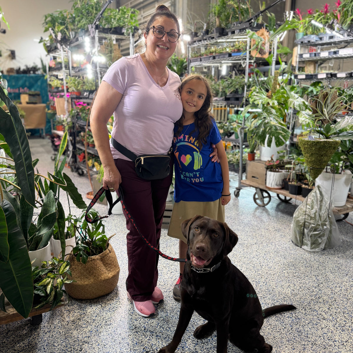 Woman, young girl, and dog in a plant store
