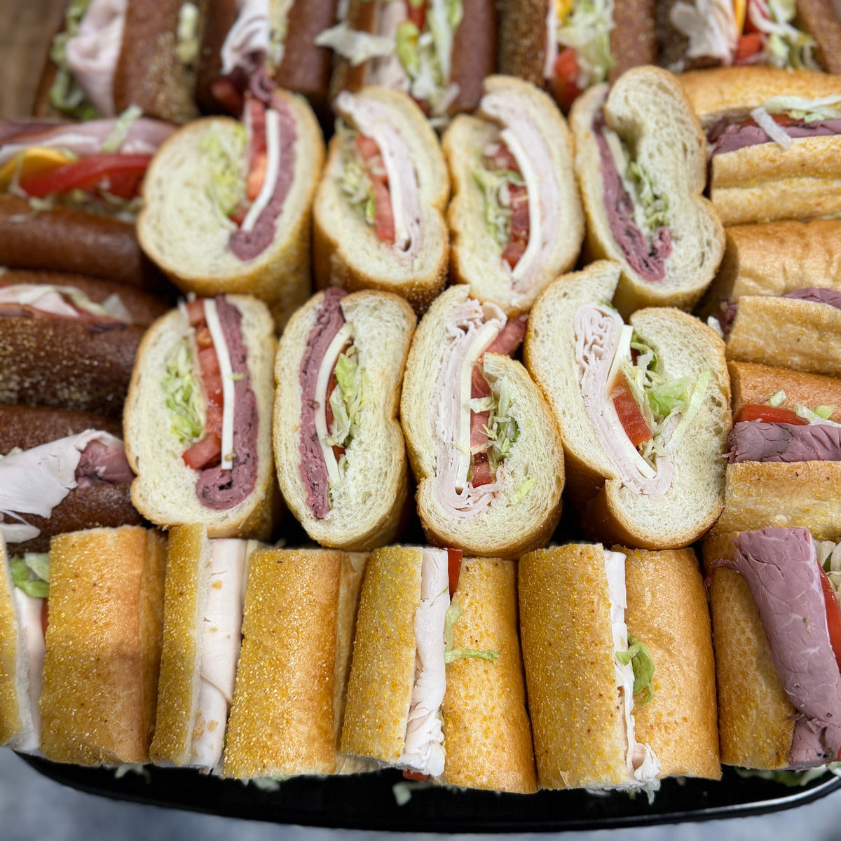 Assorted sliced sandwiches on a platter